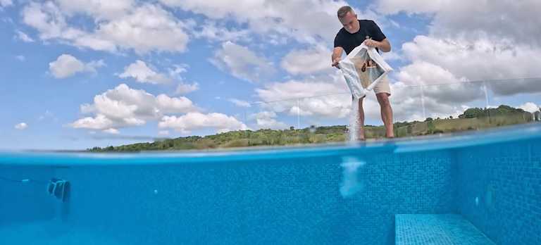 Man placing Mineral Swim to his pool.