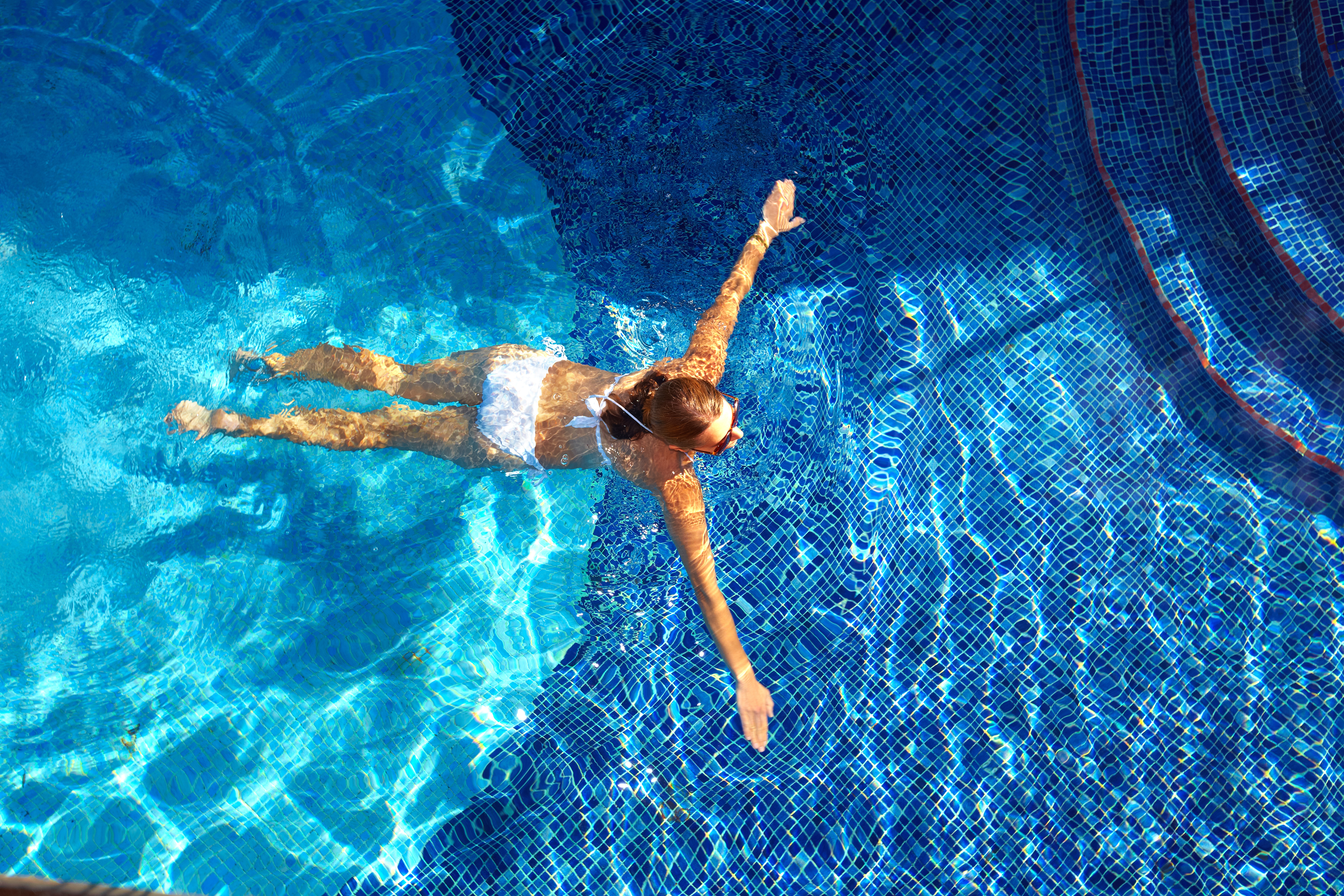 girl swimming in crystal clear mineral pool