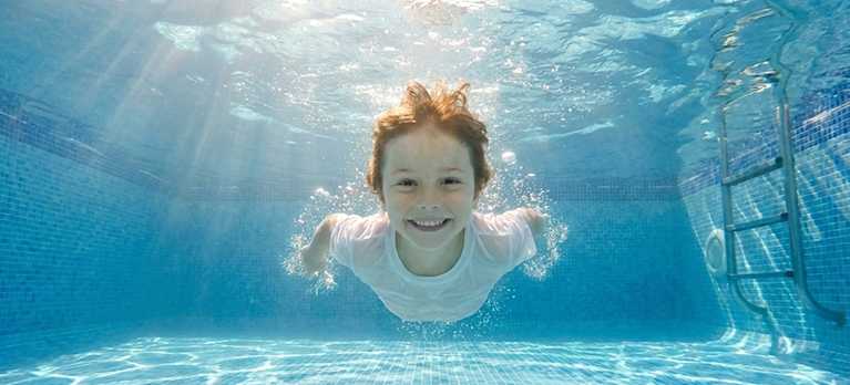child swimming in a magnesium for pools