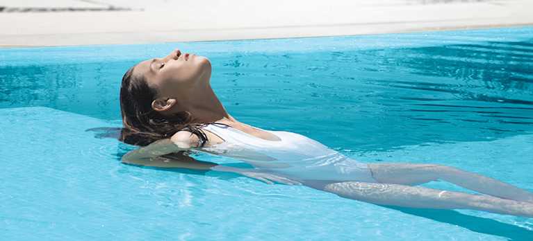 woman floating on magnesium pool