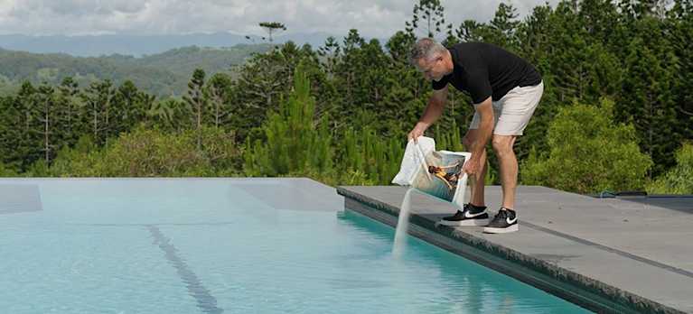 man putting mineral swim to a magnesium pool