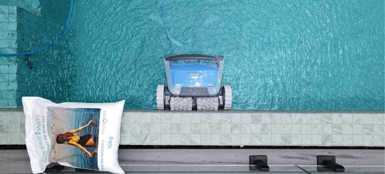 Robotic Pool Cleaner moving up on the pool with a Mineral Swim