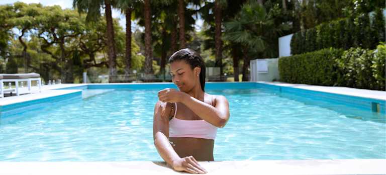 Mineral Swim is Gentle on Sensitive Skin Woman fixing her swimsuit.
