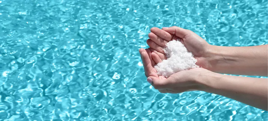 Hand with Mineral Swim chemicals.