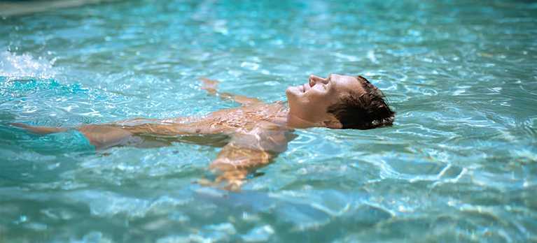 man floating in a magnesium swimming pool