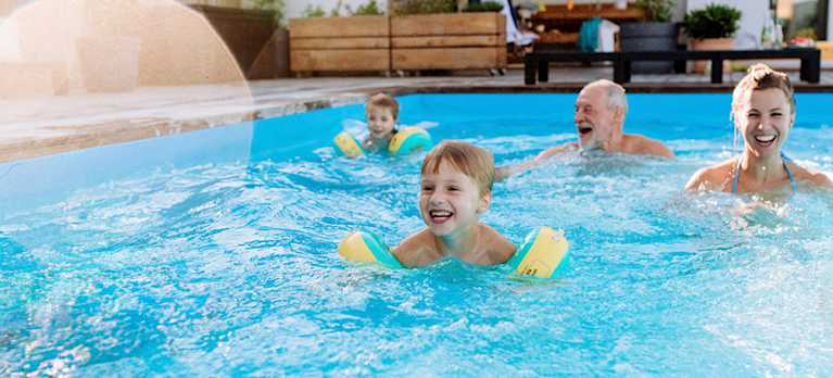 family swimming in a magnesium for pools benefits