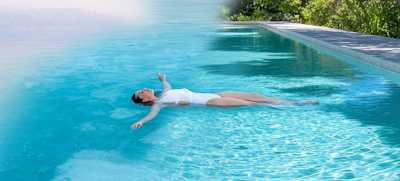 woman floating on a magnesium swimming pool