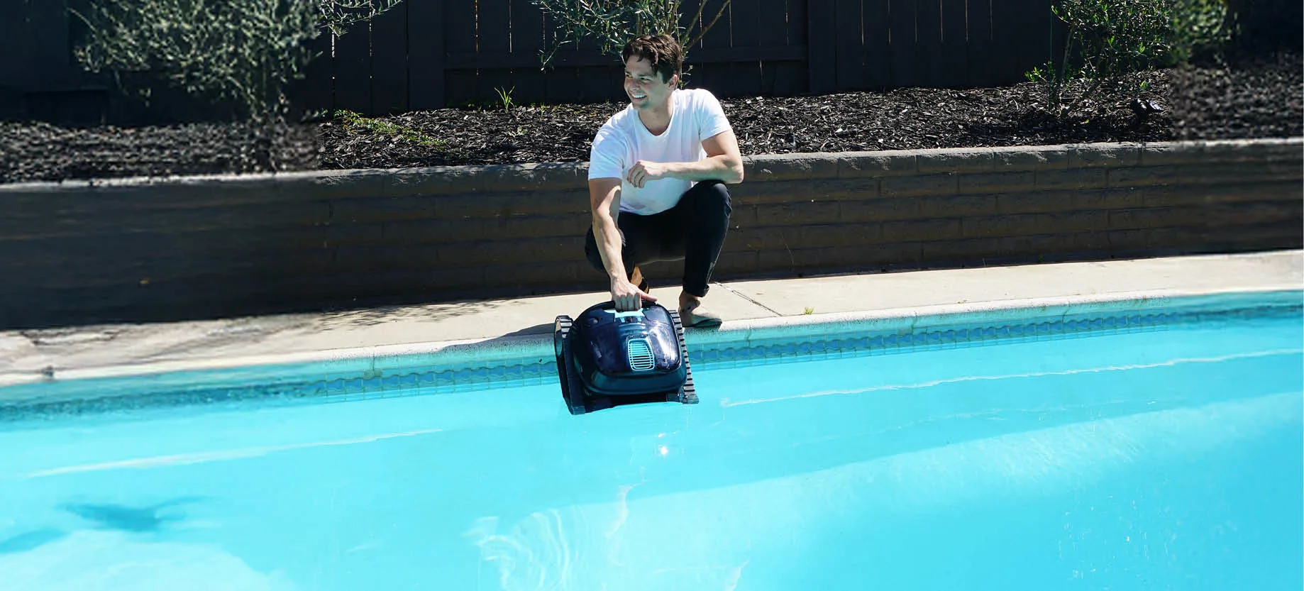 Man with a robotic pool on a pool.