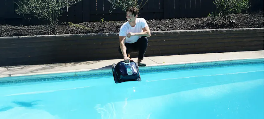 Man with a robotic pool on a pool.