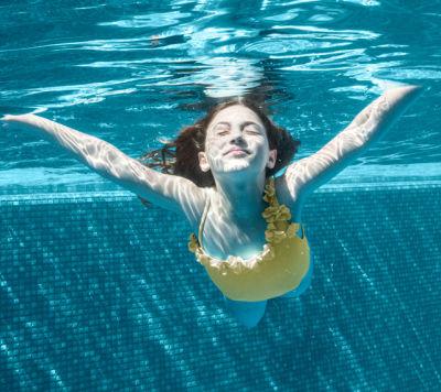 Girl underwater in an eco-friendly swimming pool