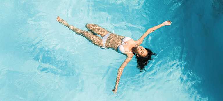 woman floating on a mineral swim magnesium pool
