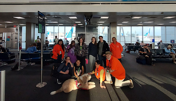 Snickers Therapy Dog poses with passengers