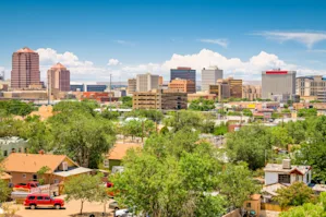 Aerial view of downtown Rio Rancho, NM with buildings and skyscrapers in the background.