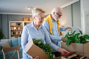Senior couple packing items in boxes