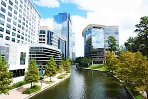 A river running through a city between buildings in Spring, TX