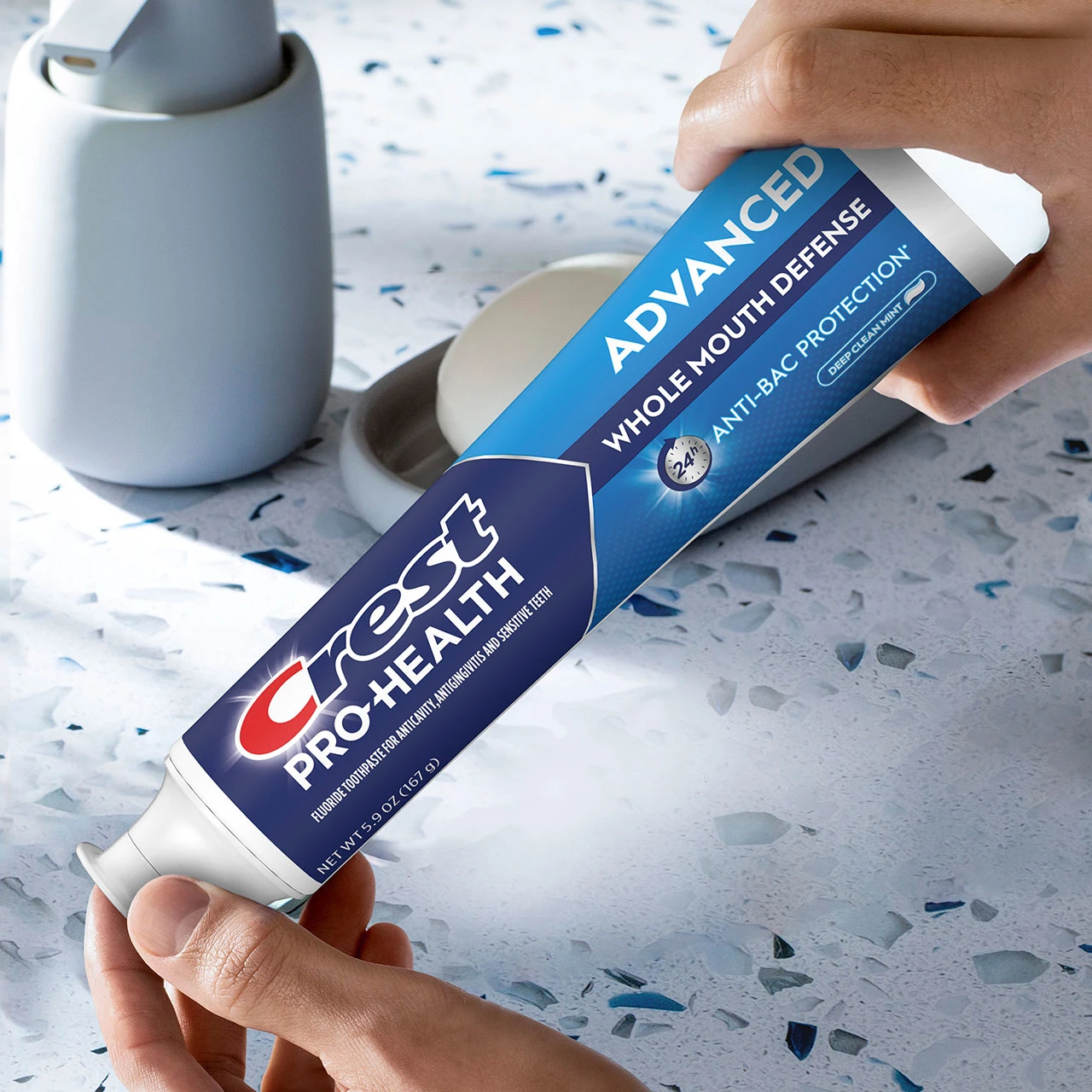 Man holding the Crest Pro-Health Advanced Whole Mouth Defense Toothpaste