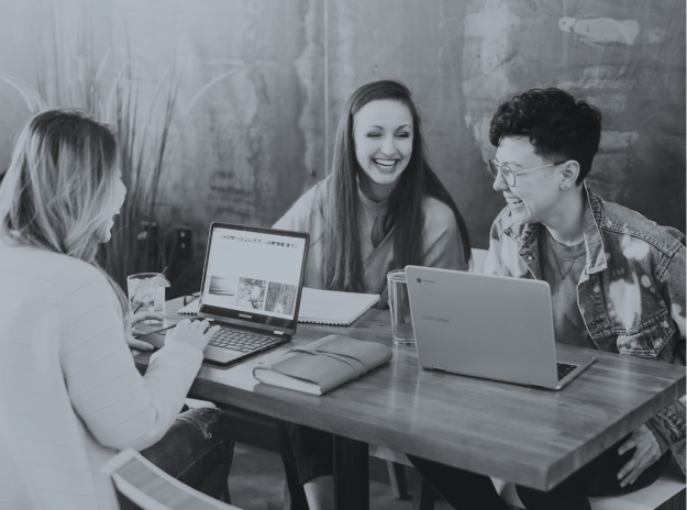 Group of people laughing with computers