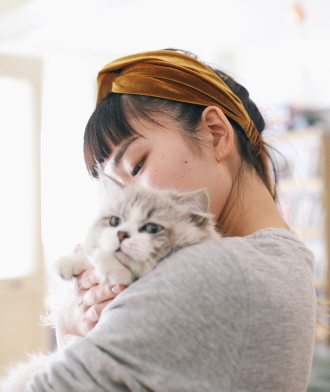 woman holding a cat in her arms