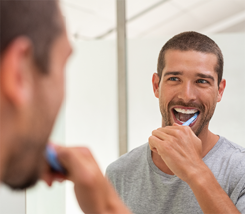 man brushing his teeth