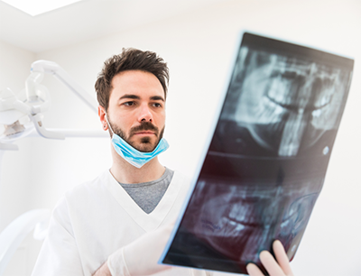 dentist examining a dental x-ray