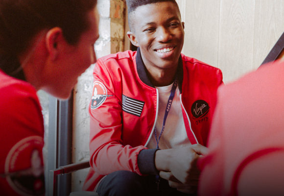 A man wearing red custom bomber jacket