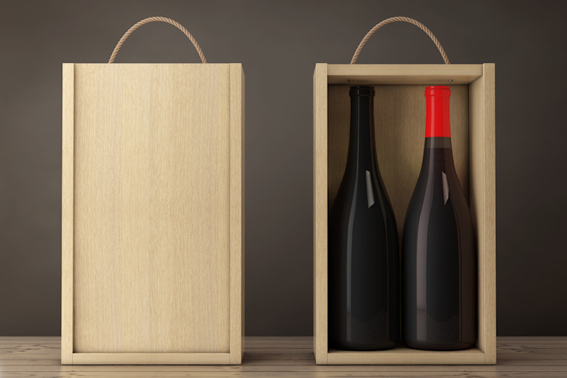 Two wooden gift boxes for wine, one with the lid closed, the other containing two bottles of red wine