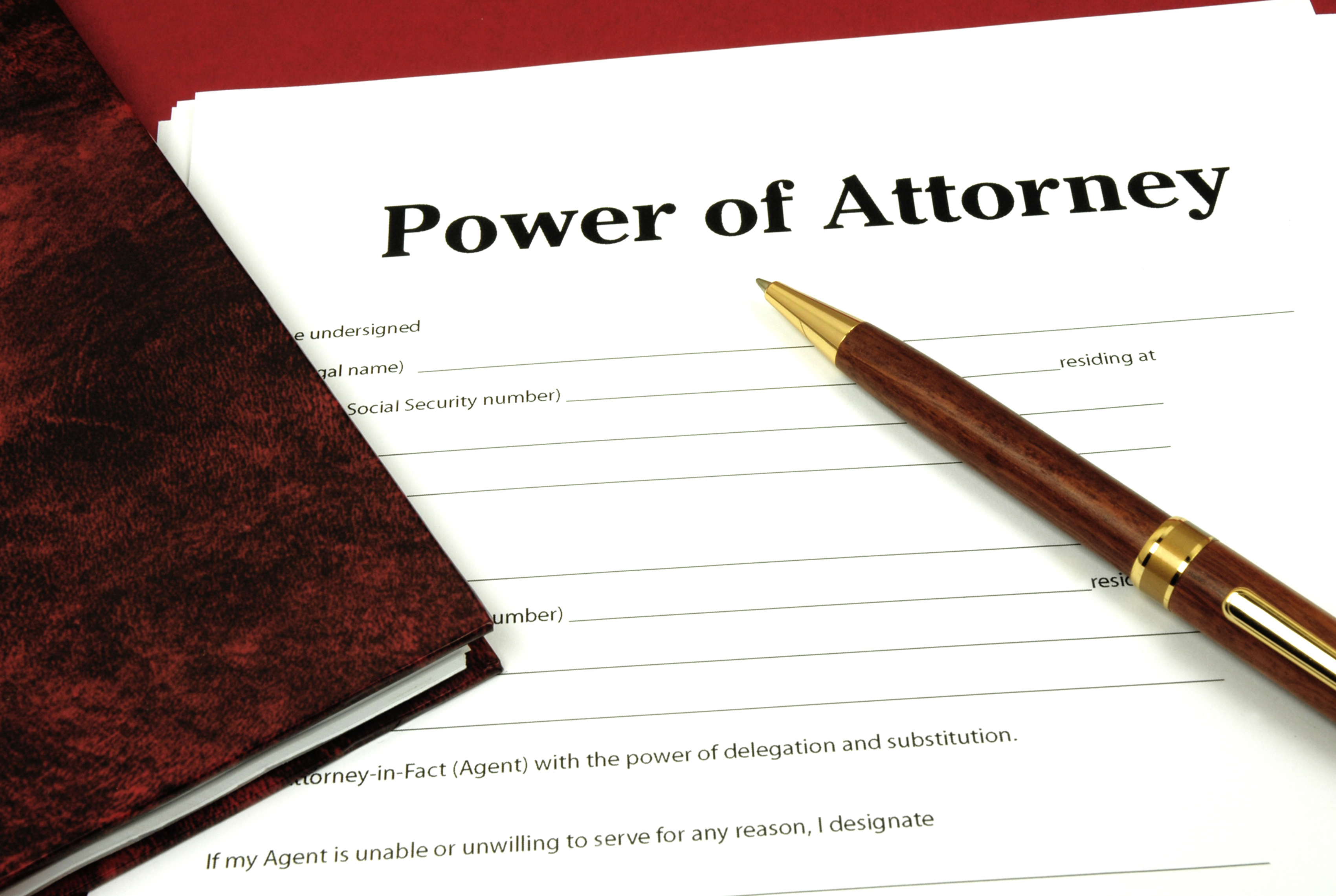 power of attorney document with pen resting on top