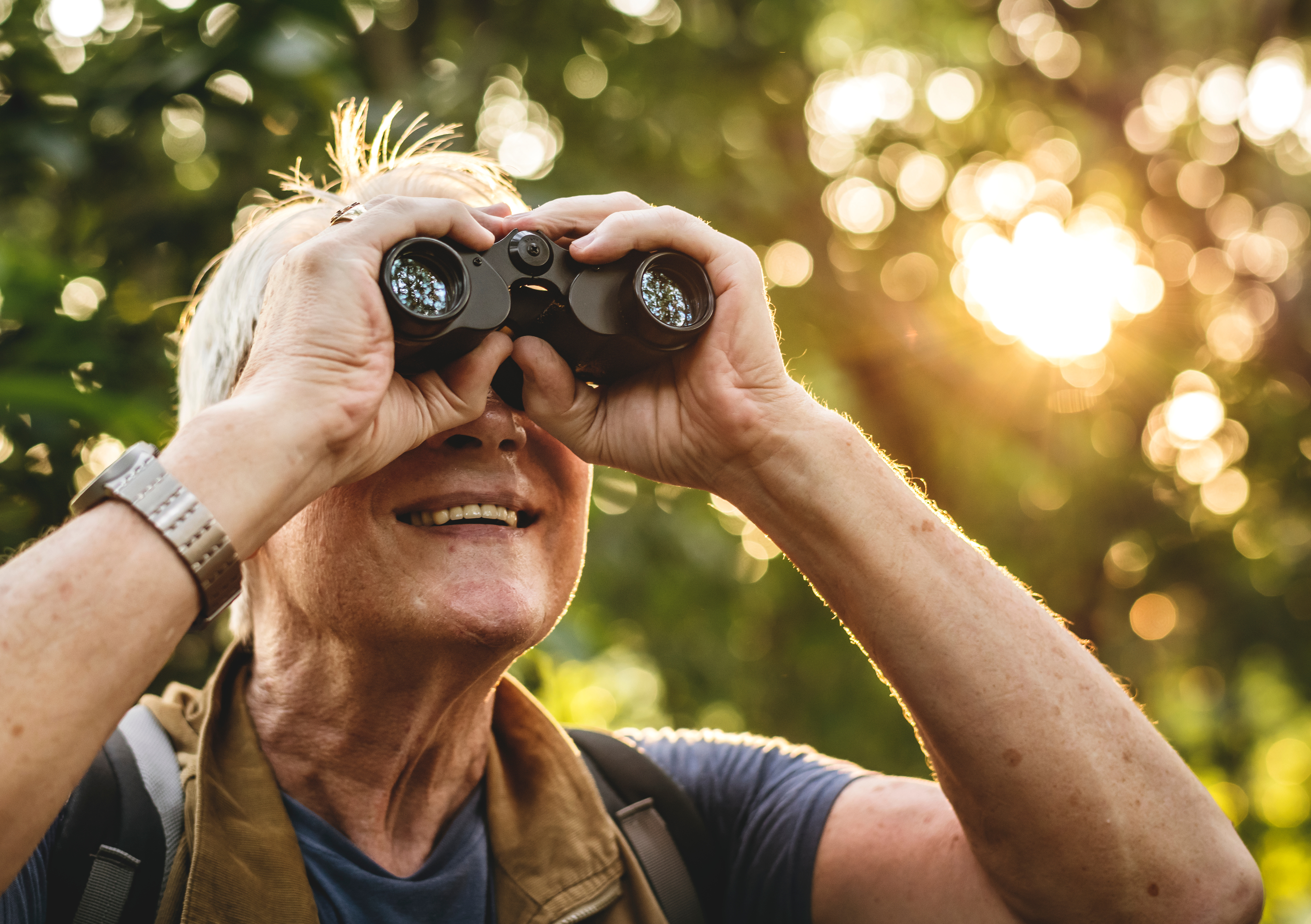 senior bird watching with binoculars