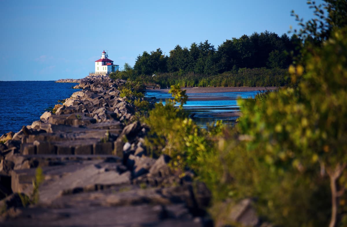 view of lighthouse and forested hill
