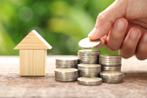 What will the latest energy price hikes mean for you? Person stacking coins on top of each other.