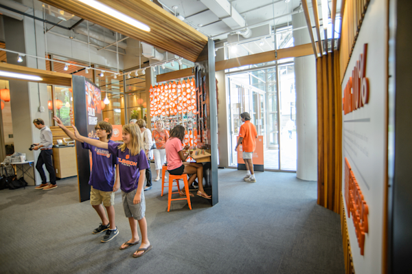 Children navigating the different videos in the Clemson Family Portrait.