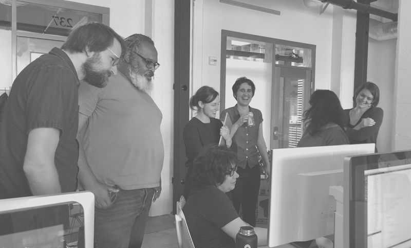 Seven Upswell team members reviewing a project