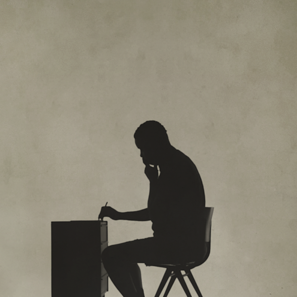 Silhouette of Nelson Mandela at his writing desk in the cell, as recreated by an actor.
