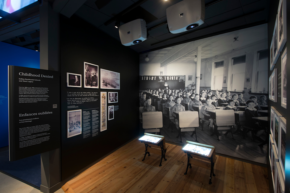 Film projection juxtaposed with poignant exhibit content.
