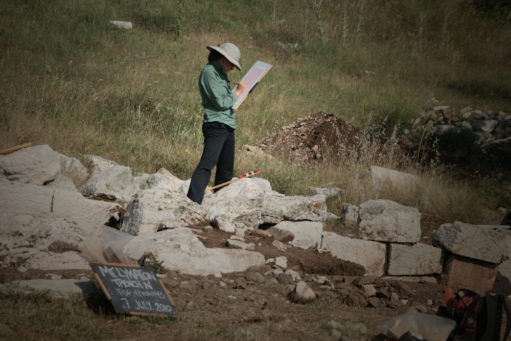 Researcher taking notes at the Mt. Lykaion archaeological dig site.