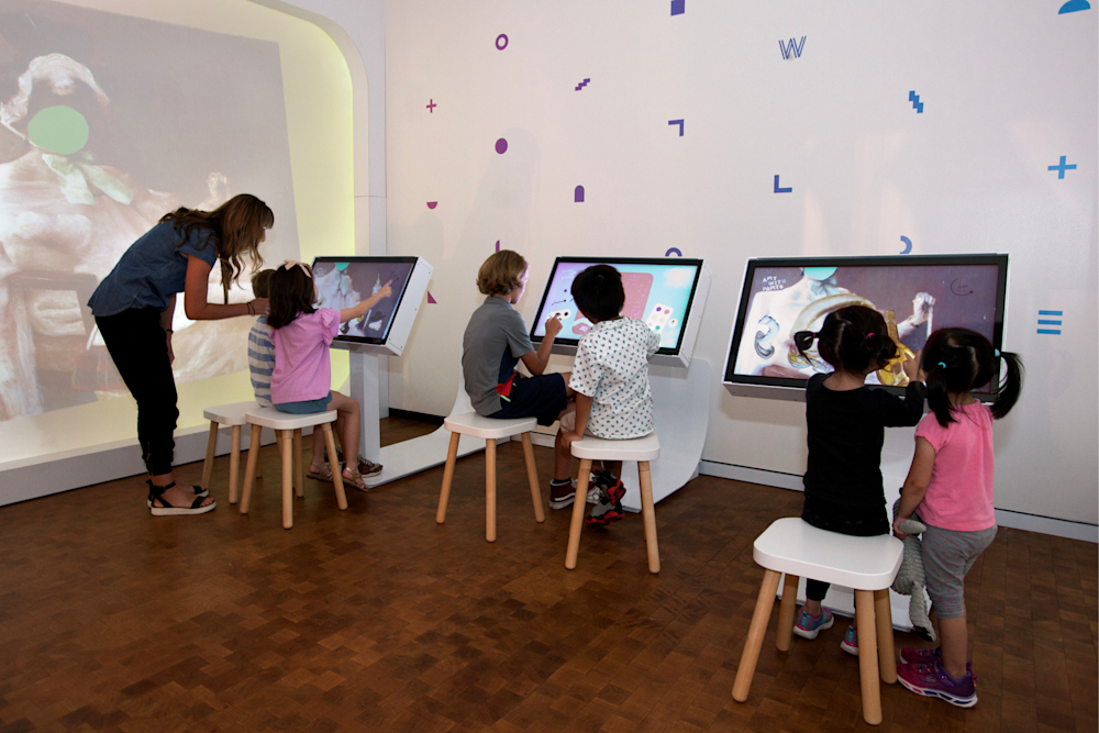 Young kids try their hand at making collages with artwork parts, or doodle on a Chrysler collection artworks.