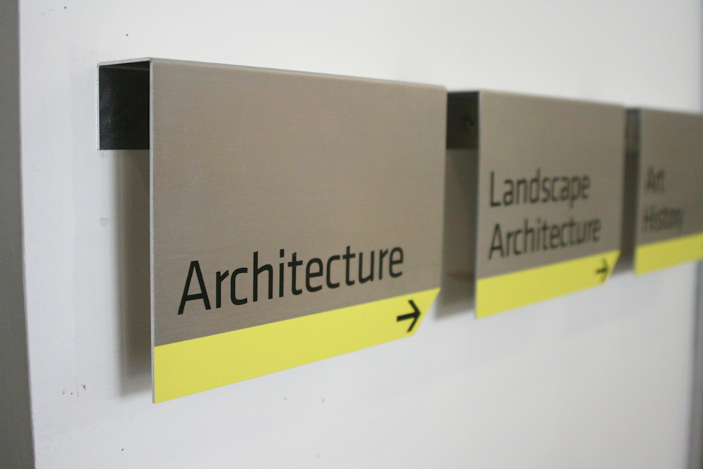 Row of three signs: Architecture, Landscape Architecture and Art History mounted on a wall at the University of Oregon College of Design