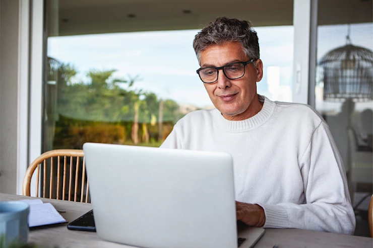 dearborn - man at home on laptop