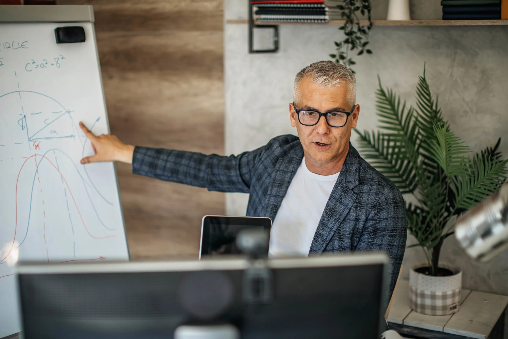 man with glasses presenting virtually