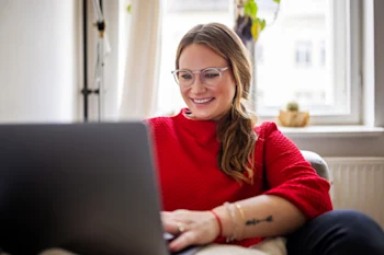 Student smiling looking at laptop