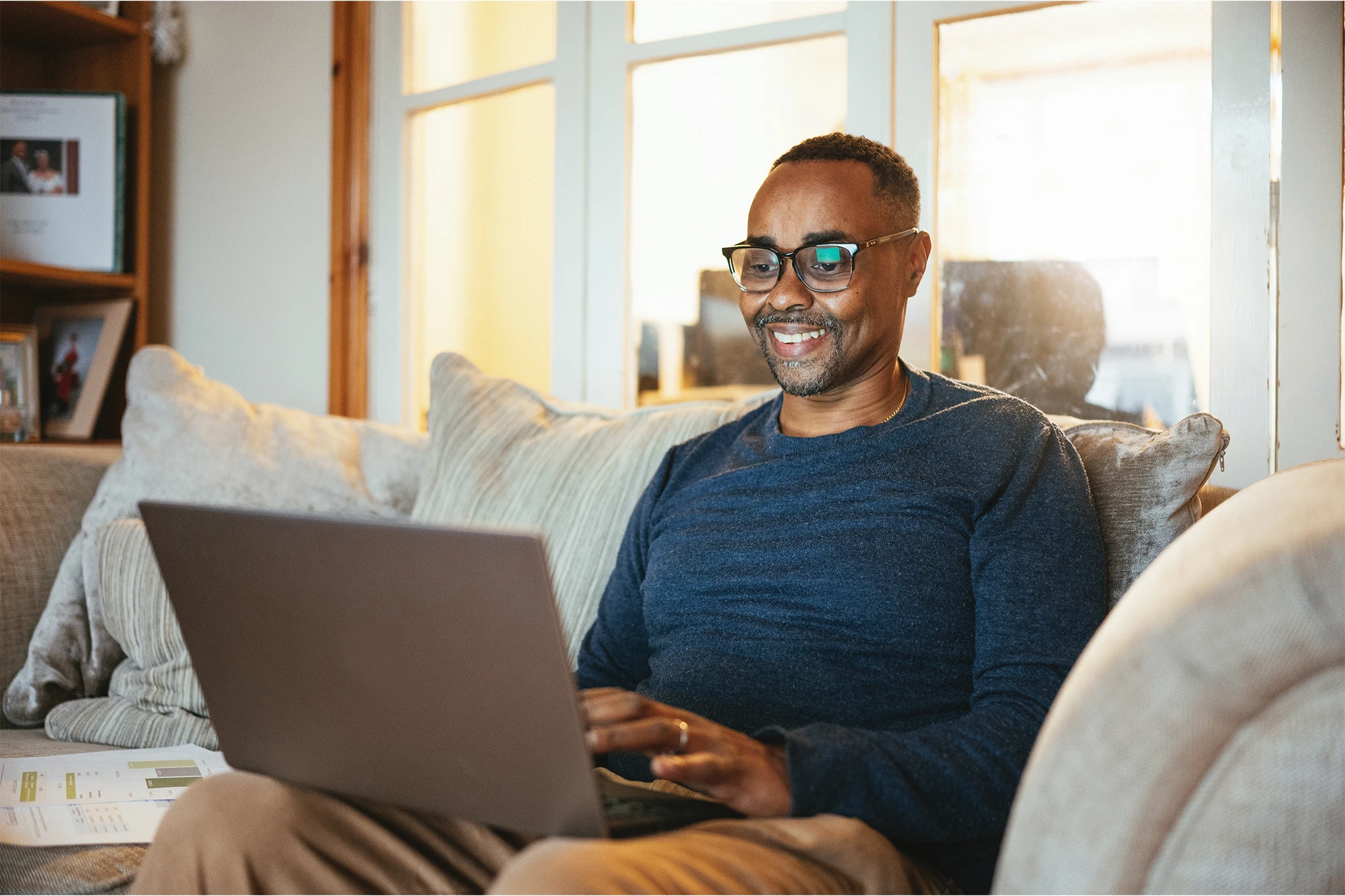 Real Estate Professional Sitting On a Sofa Conducting Research