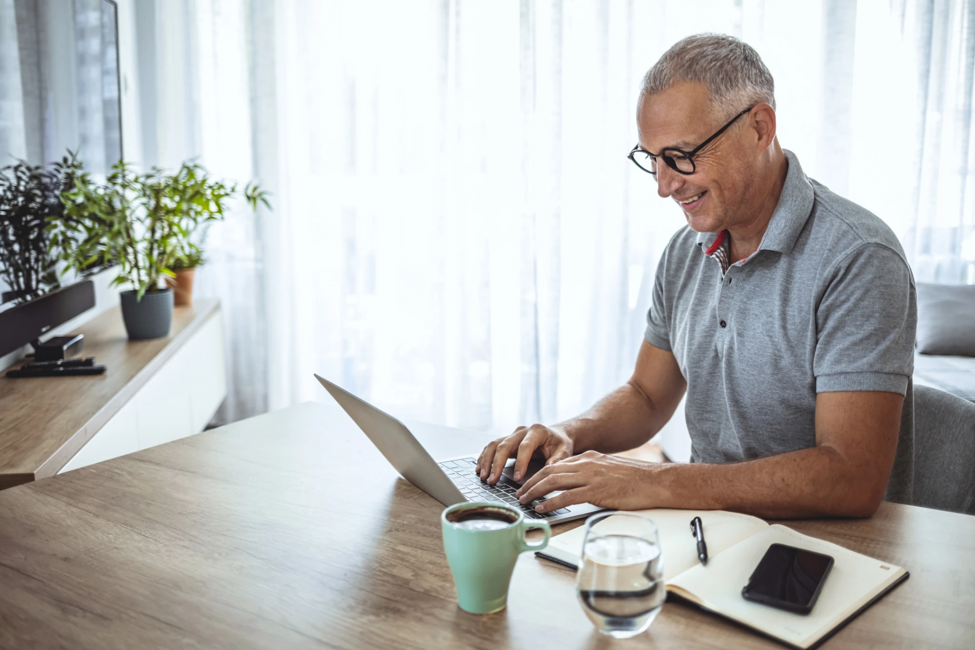 CFFP - man sitting at table working on laptop