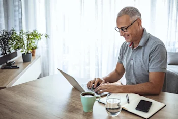 CFFP - man sitting at table working on laptop