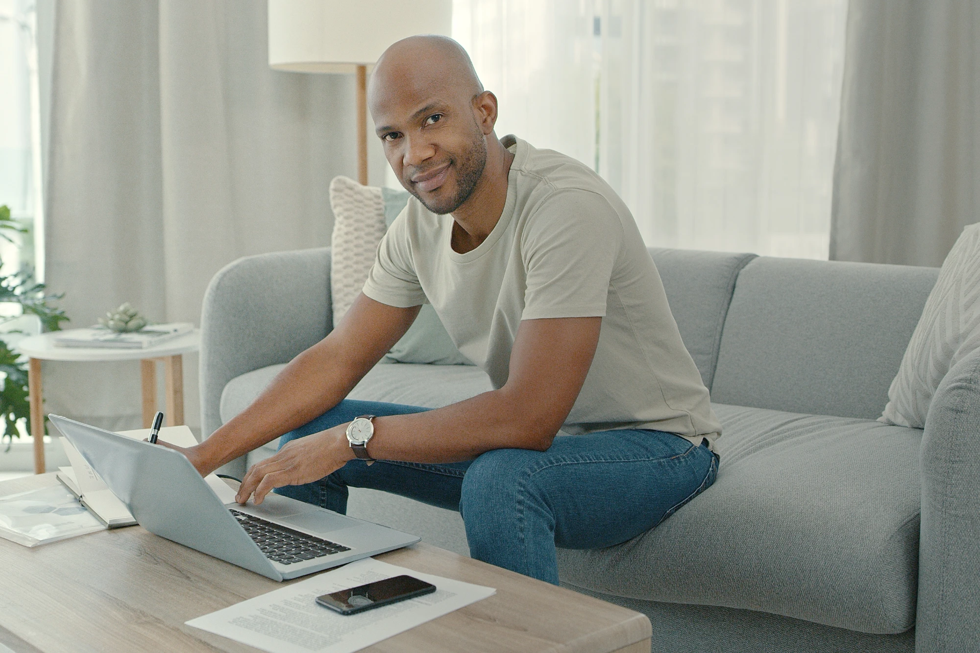 CFFP - man sitting on couch working on laptop