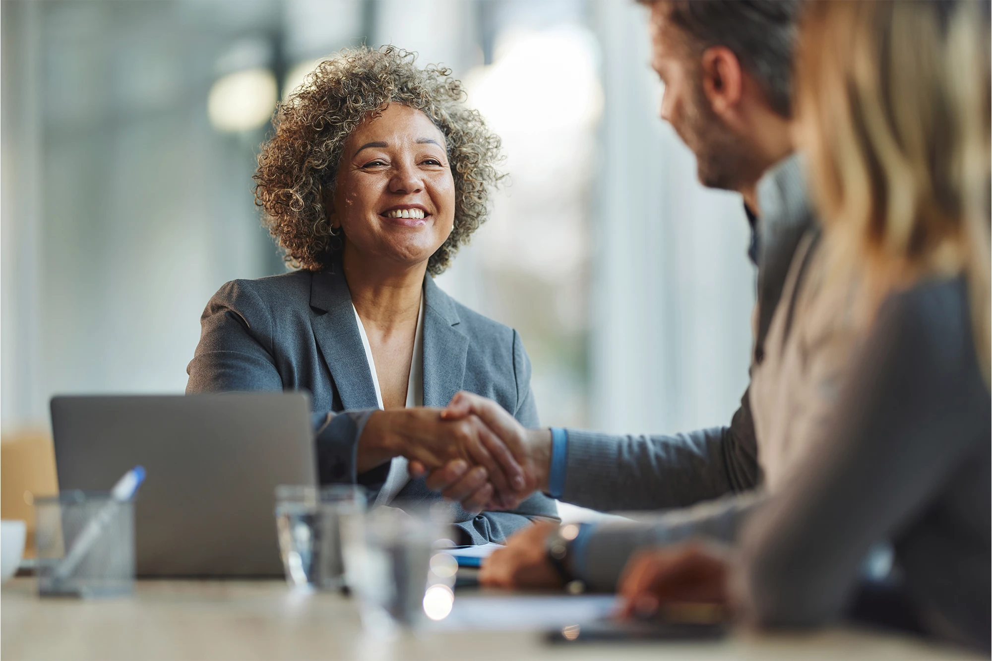 dearborn - woman shaking man hand at meeting