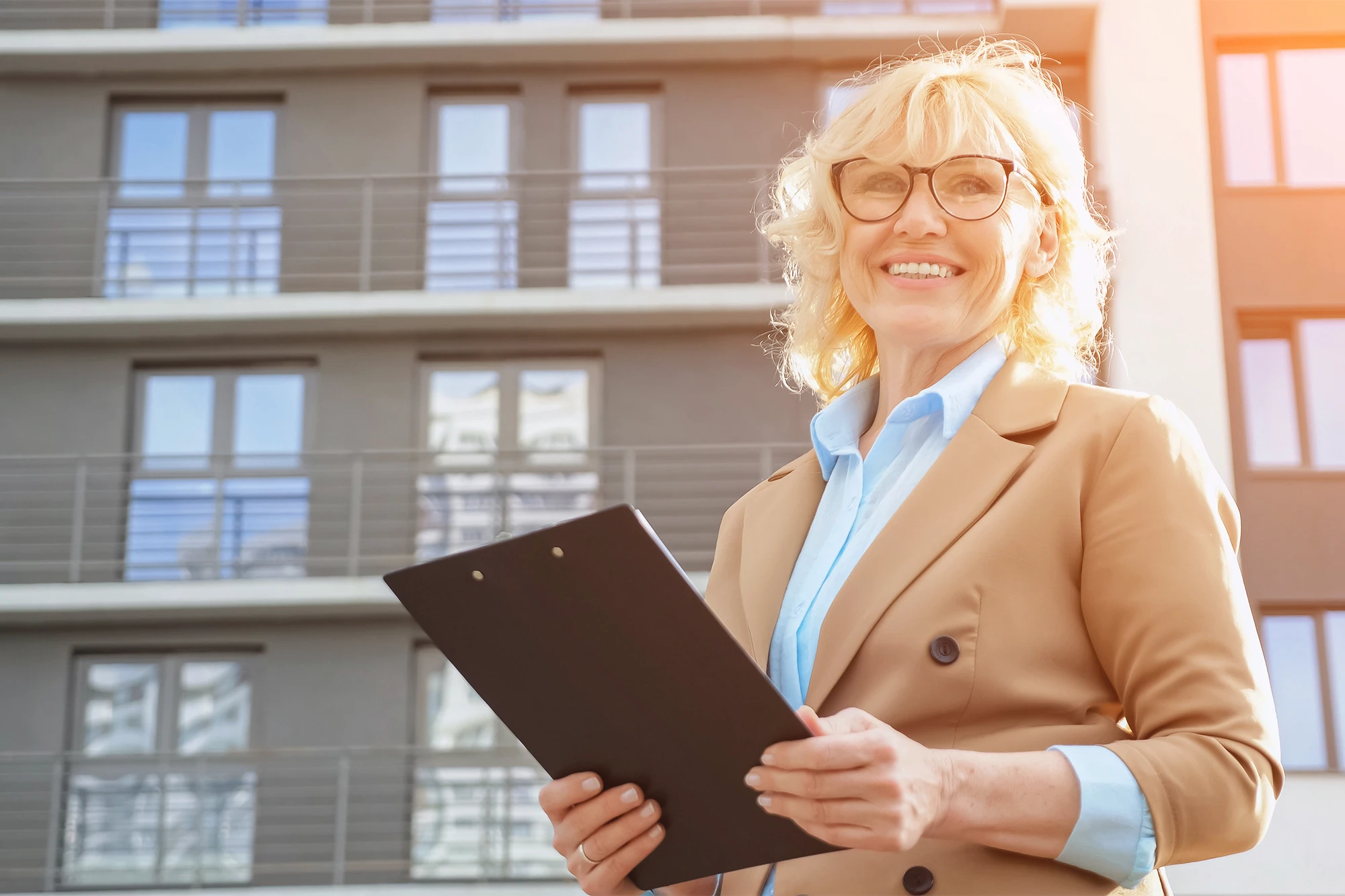 dearborn - smiling woman outdoors with clipboard