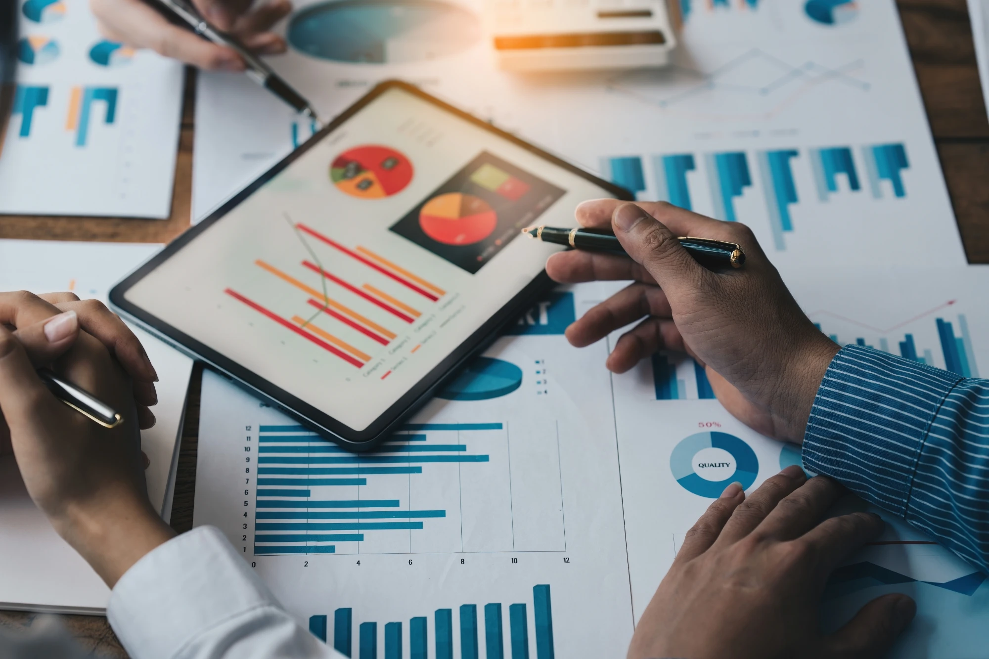 CFFP - group of people in meeting looking at charts on tablet