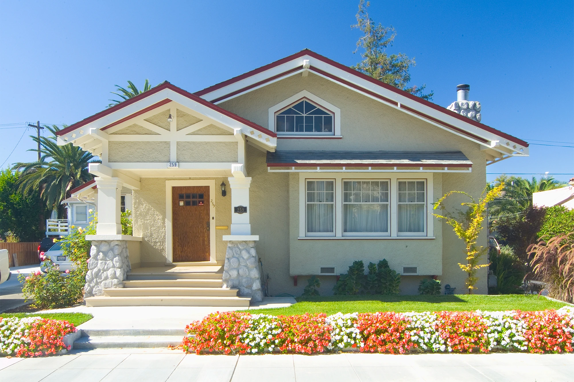 dearborn - tan house with red and white flowers