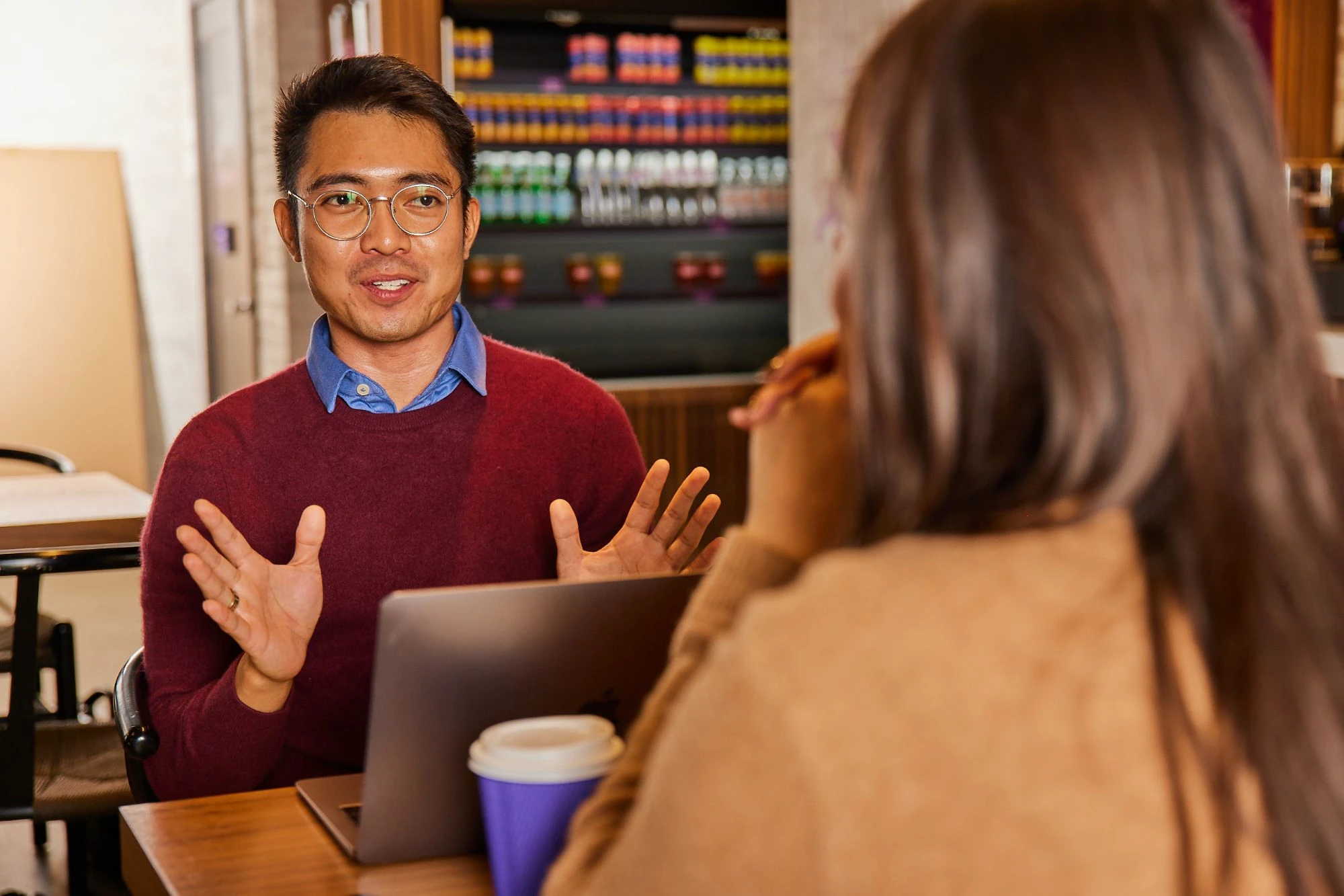 Man with laptop and woman meeting