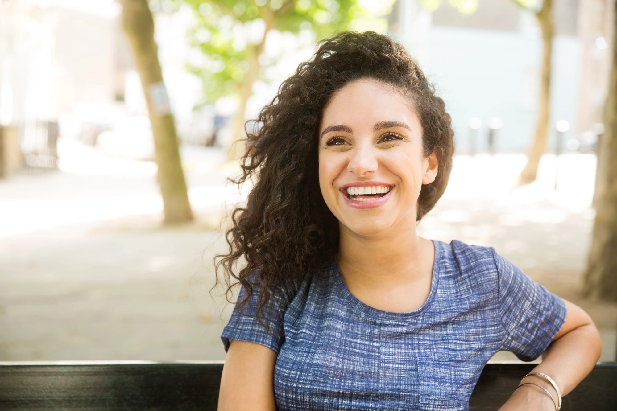 woman sitting on on a bench outdoors